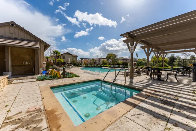 a view of a swimming pool with sitting area