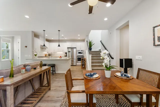 a open dining room with furniture and wooden floor