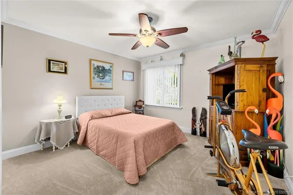 a spacious bedroom with a bed and a chandelier