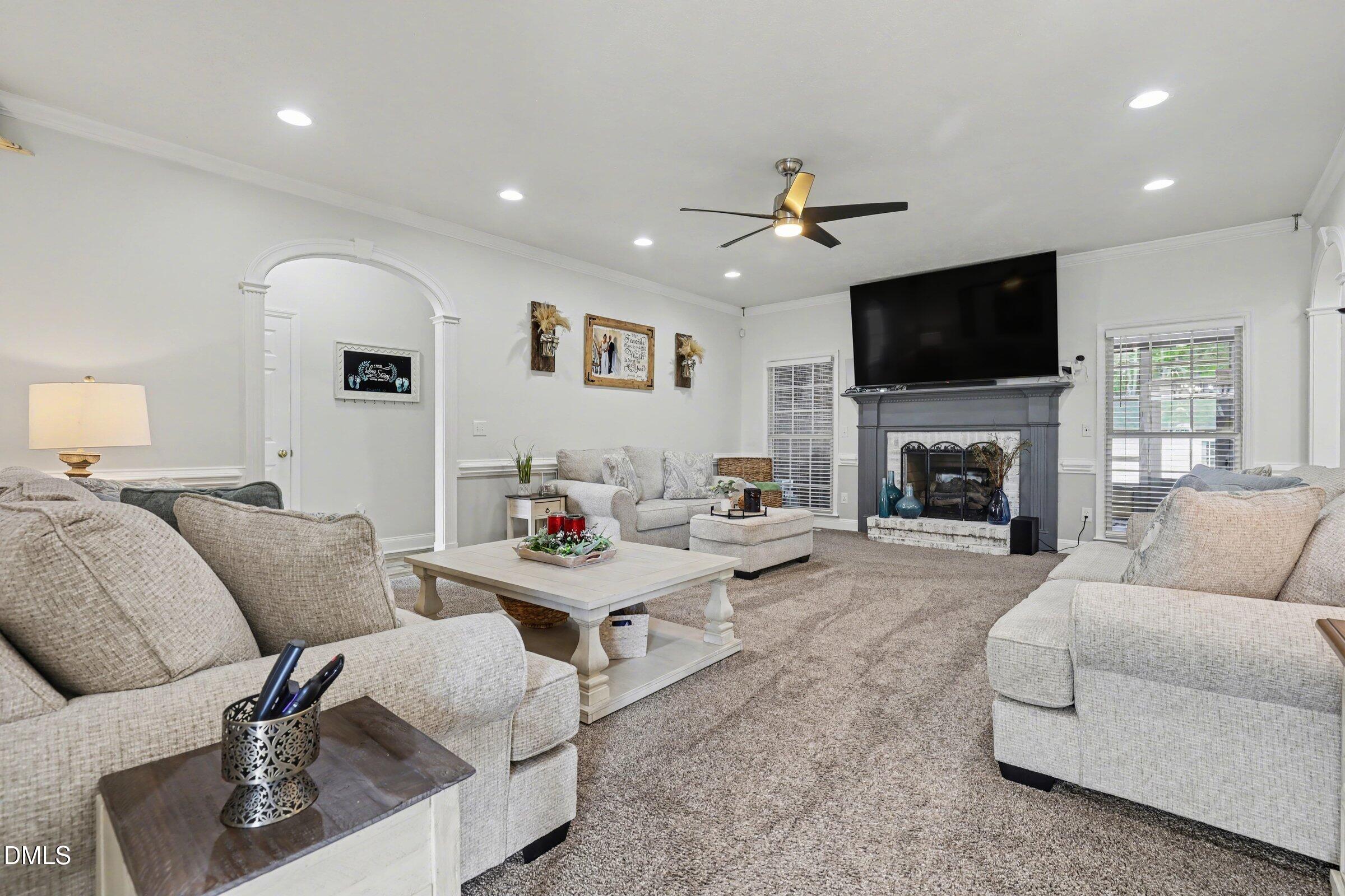430 Fred Hall Road Stedman, NC 28391 - Photo 4 of 63 a living room with furniture a fireplace and a flat screen tv
