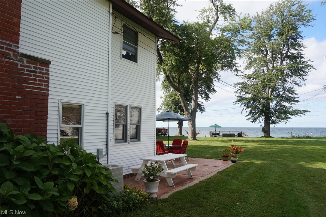 7311 Lake Road East Madison, OH 44057 - Photo 25 of 35 View of yard featuring a patio, a water view, open yard space.