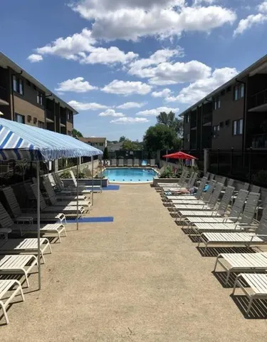 a view of a swimming pool with lawn chairs