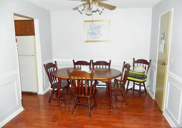 a view of a dining room with furniture and wooden floor