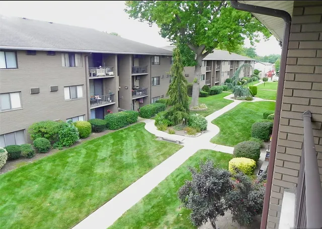 a view of a house with a backyard and a garden
