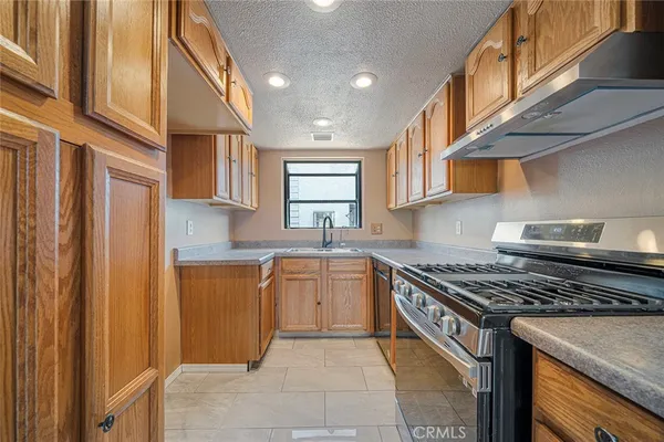a kitchen with stainless steel appliances granite countertop a stove and a sink