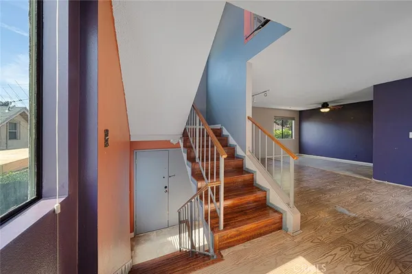 a view of entryway and hall with wooden floor