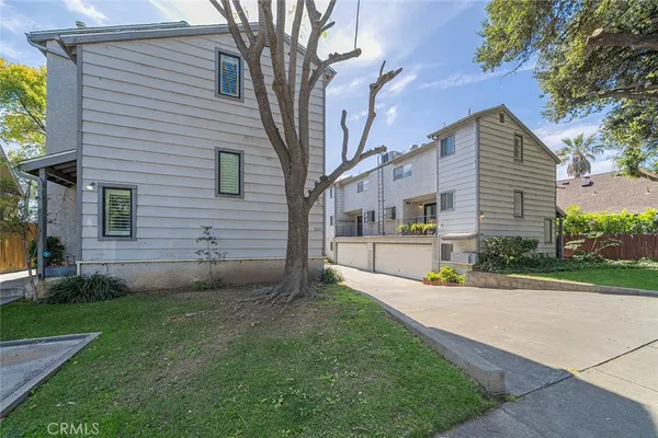 a front view of a house with a yard and a garage