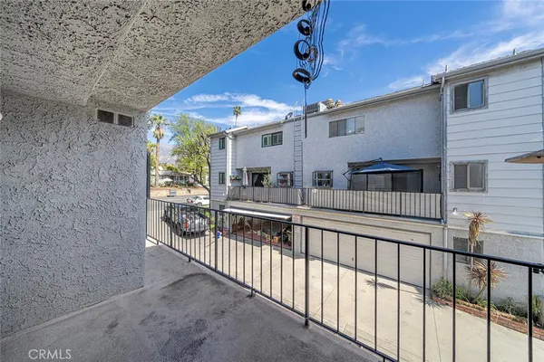 a view of a porch with two chairs and a large window