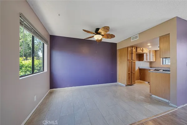 a view of a livingroom with a kitchen and window