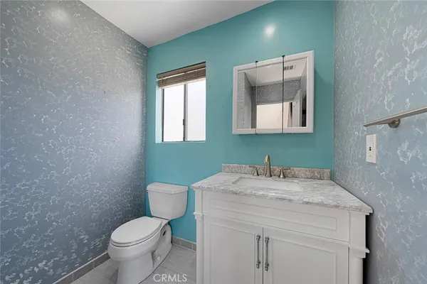 a bathroom with a sink toilet and mirror