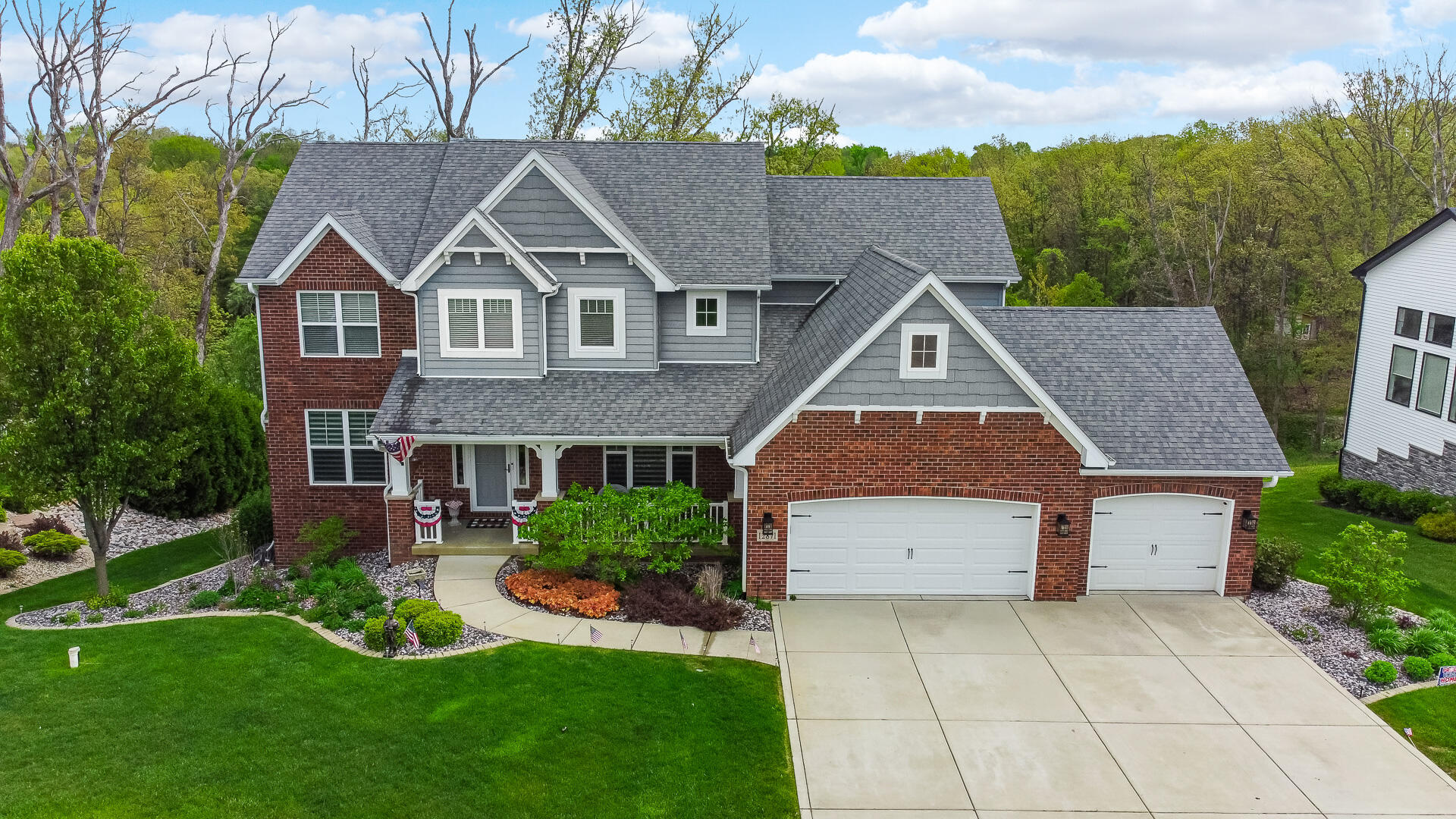 a aerial view of house with a yard and potted plants