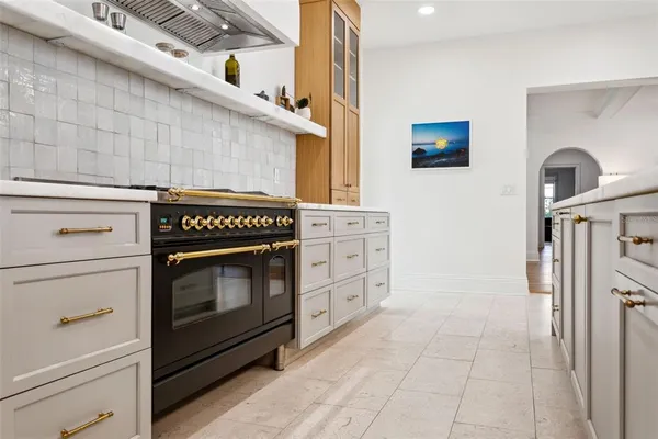 a kitchen with cabinets and a stove top oven