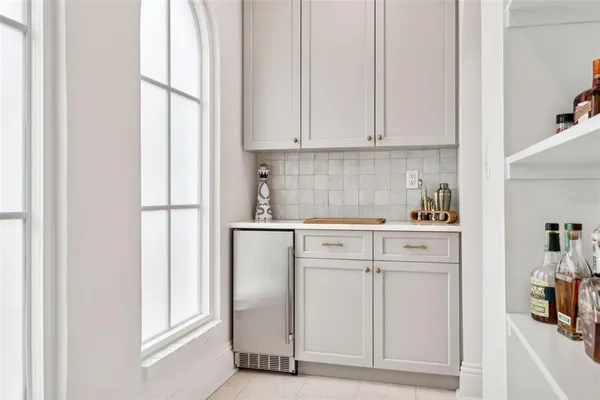 a kitchen with white cabinets and white appliances