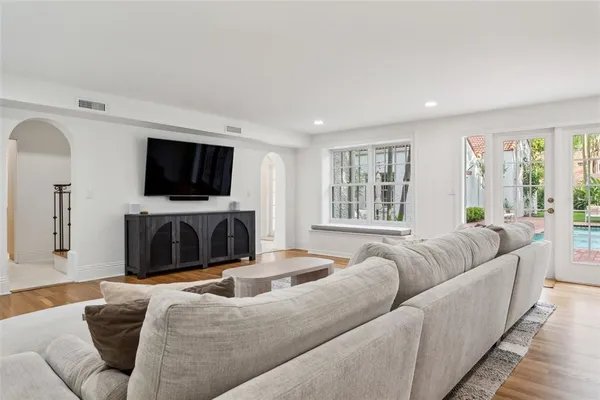 a living room with furniture a flat screen tv and a fireplace