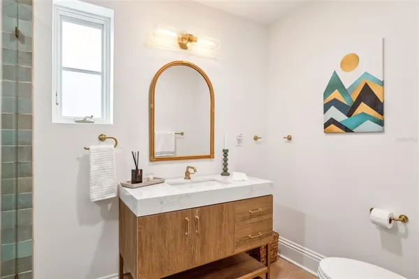 a bathroom with a sink a mirror and a toilet