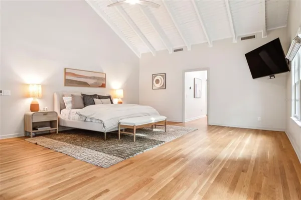 a bedroom with a bed and flat screen tv