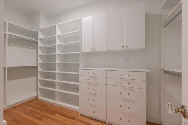 a view white cabinets with wooden floor