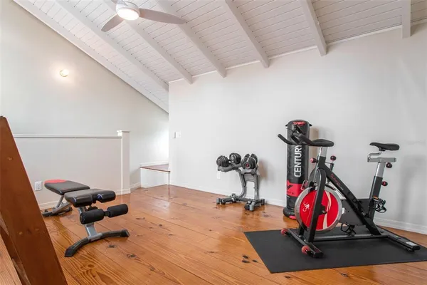 a room with gym equipment and air hockey table