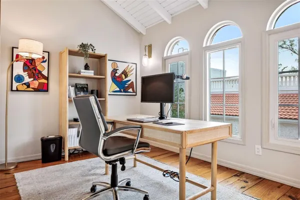 a view of a workspace with furniture and a window