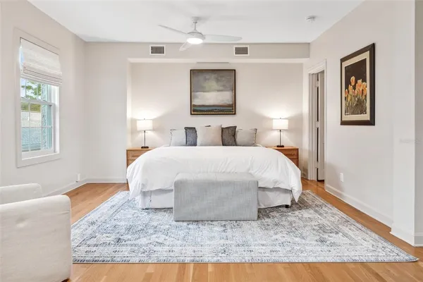 a bed sitting in a bedroom next to a window