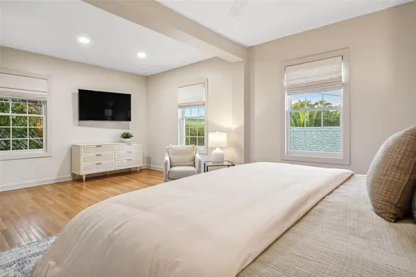 a bedroom with a bed and a flat screen tv