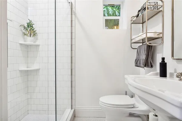 a bathroom with a toilet a sink and a shower