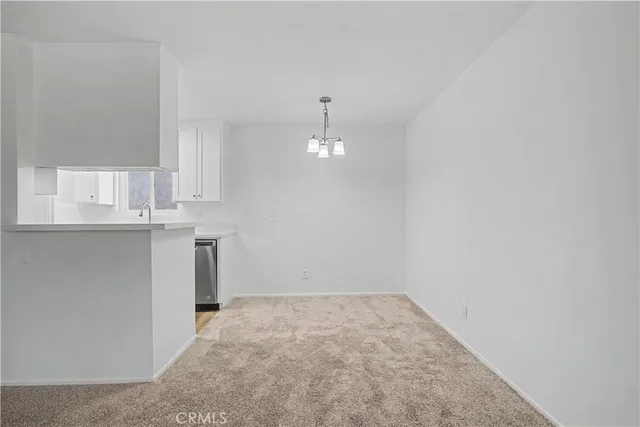 an empty room with a kitchen