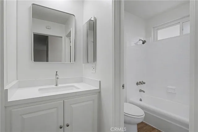 a bedroom with a bed and painting on the wall