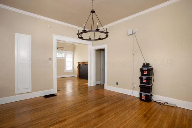 a view of a room with wooden floor entryway and windows