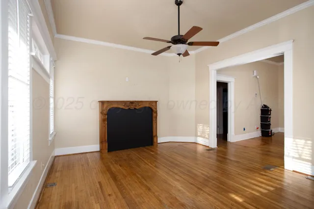 a view of empty room with wooden floor