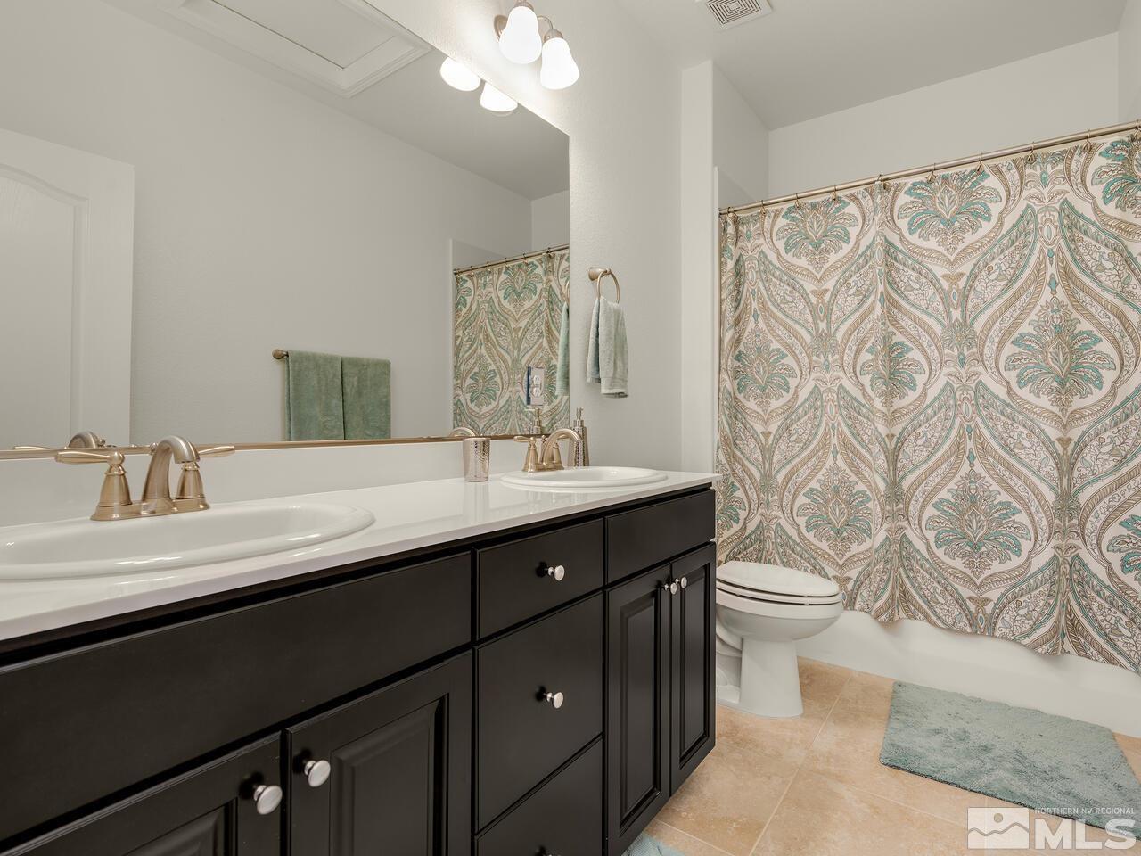 1770 Scott Valley Road Reno, NV 89523 - Photo 19 of 29 a bathroom with a double vanity sink toilet and a mirror
