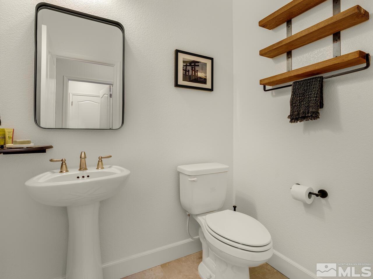 1770 Scott Valley Road Reno, NV 89523 - Photo 20 of 29 a bathroom with a toilet a sink and mirror
