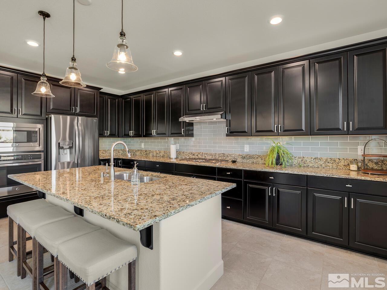 1770 Scott Valley Road Reno, NV 89523 - Photo 10 of 29 a kitchen with kitchen island granite countertop a sink a center island stainless steel appliances and cabinets