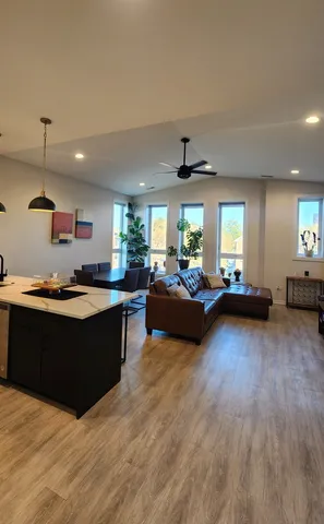 a living room with furniture and a wooden floor