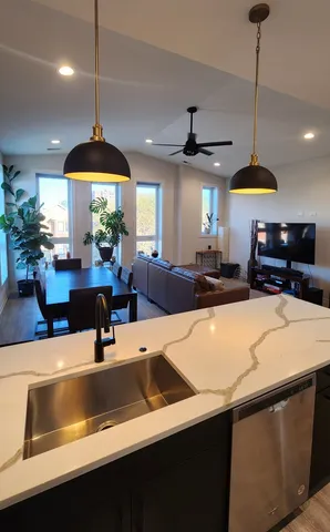 a kitchen with a counter space a sink and a window