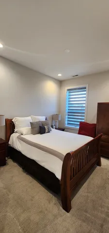 a bedroom with a bed and window