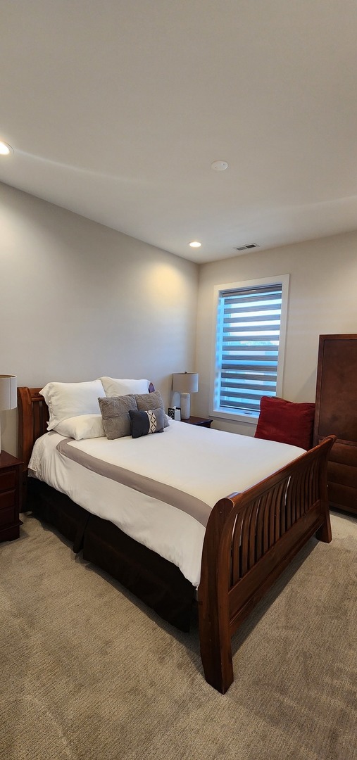 4902 South St Lawrence Avenue, Unit 2 Chicago, IL 60615 - Photo 7 of 11 a bedroom with a bed and window