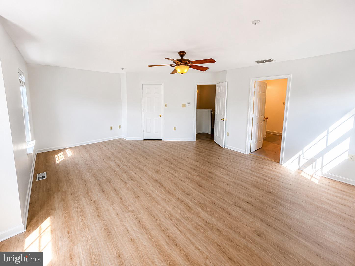 308 Assembly Point Court Odenton, MD 21113 - Photo 12 of 19 an empty room with wooden floor and windows