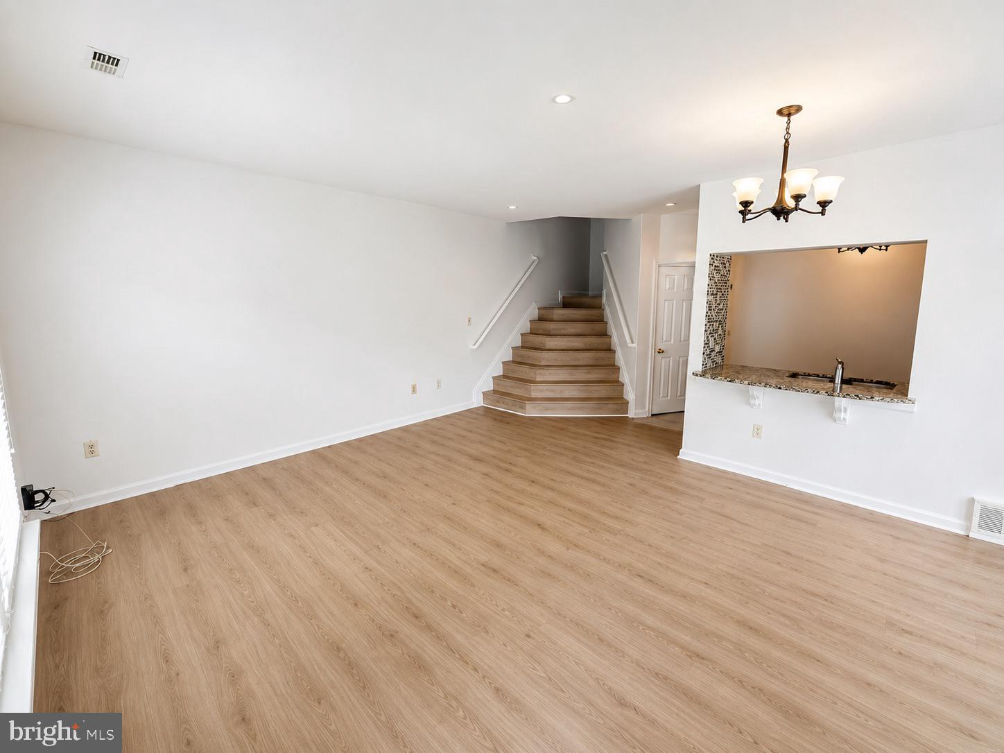 308 Assembly Point Court Odenton, MD 21113 - Photo 2 of 19 a view of an empty room with wooden floor and a window