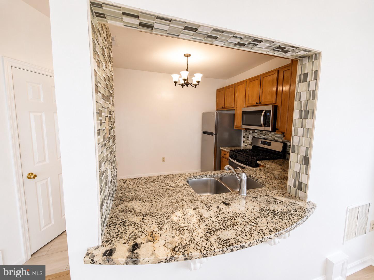 308 Assembly Point Court Odenton, MD 21113 - Photo 5 of 19 a kitchen with a sink and a mirror