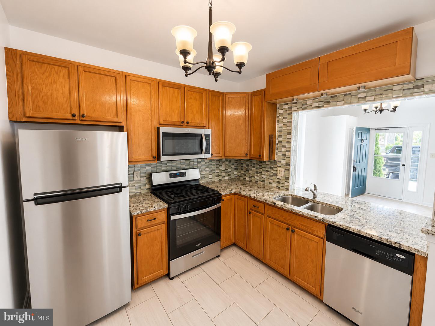 308 Assembly Point Court Odenton, MD 21113 - Photo 6 of 19 a kitchen with granite countertop stainless steel appliances and wooden cabinets