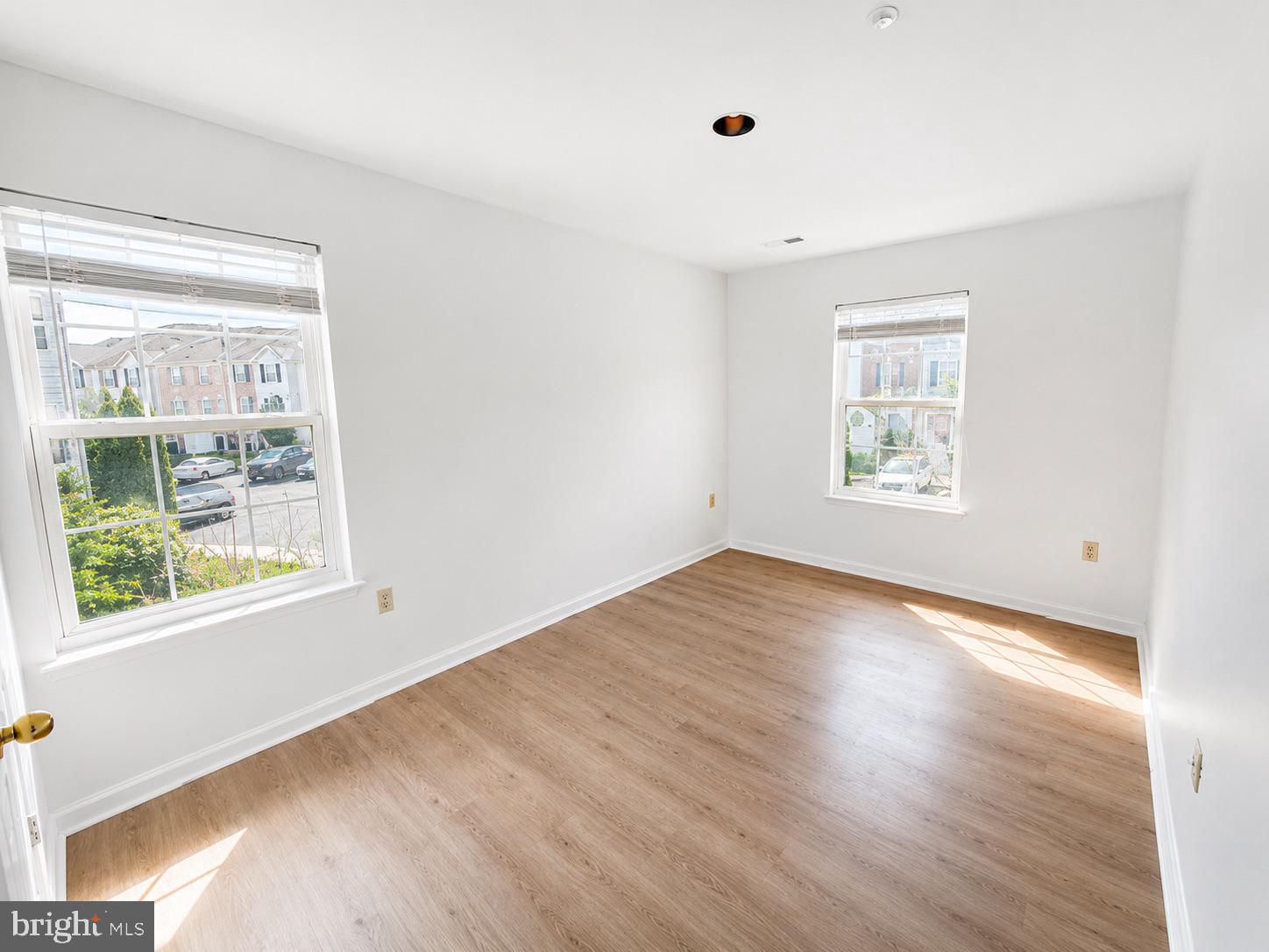 308 Assembly Point Court Odenton, MD 21113 - Photo 8 of 19 a view of empty room with wooden floor and fan