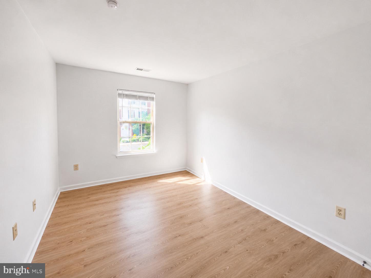 308 Assembly Point Court Odenton, MD 21113 - Photo 9 of 19 an empty room with wooden floor and windows