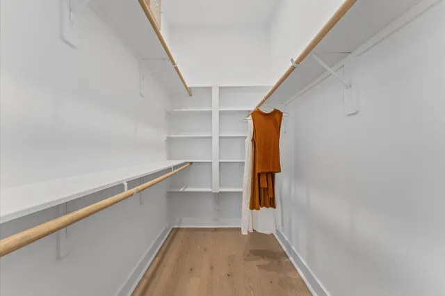 a view of walk in closet with empty racks