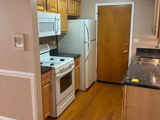a kitchen with a refrigerator sink and stove