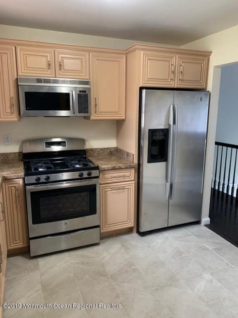 126 County Road Cliffwood, NJ 07721 - Photo 4 of 29 a kitchen with granite countertop white cabinets and stainless steel appliances