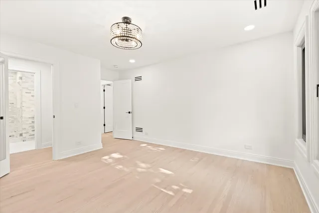 a room with a bed and wooden floor