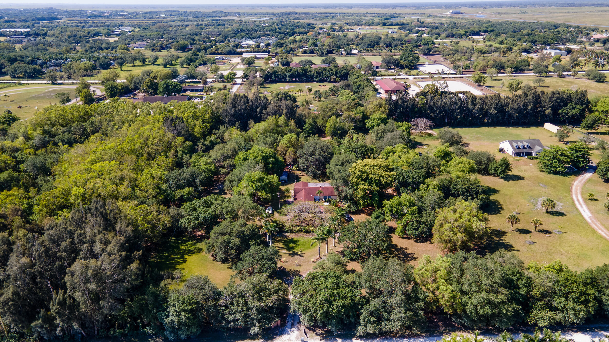 16688 Rustic Road Wellington, FL 33470 - Photo 12 of 14 an aerial view of a houses with a lake and green space
