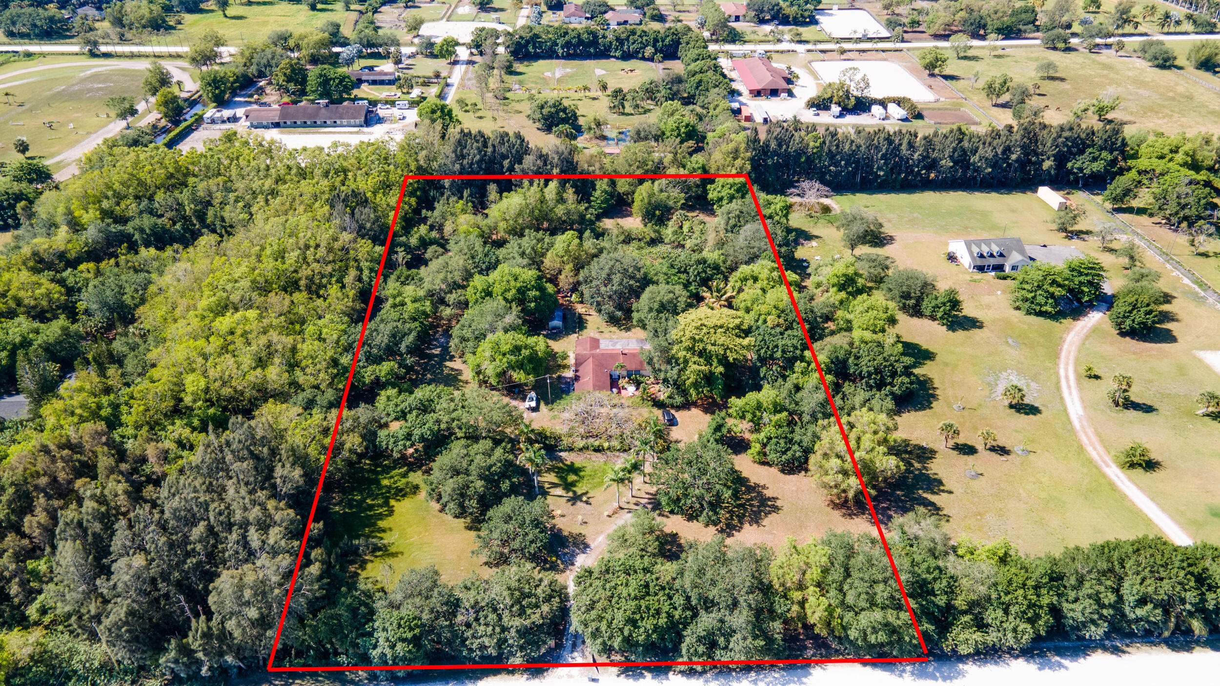 16688 Rustic Road Wellington, FL 33470 - Photo 2 of 14 an aerial view of lake and residential houses with outdoor space