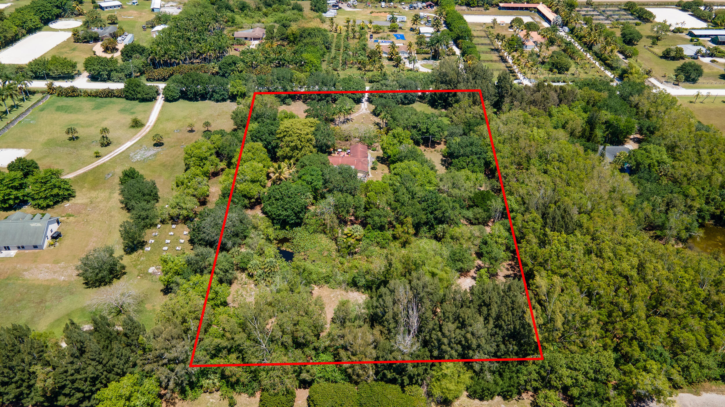 16688 Rustic Road Wellington, FL 33470 - Photo 3 of 14 an aerial view of residential house with outdoor space and trees all around